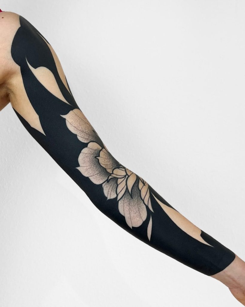 Blackwork floral sleeve tattoo