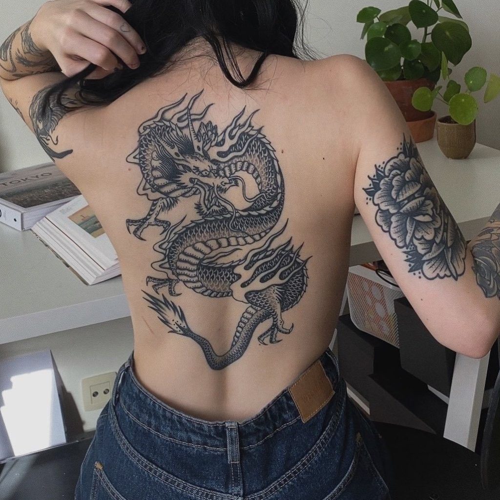 black ink dragon tattoo on back